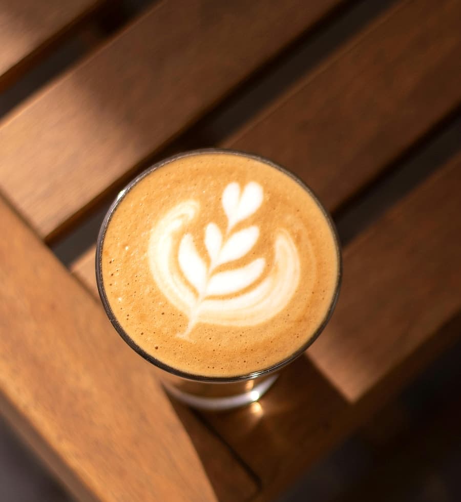Flat white au latte art net sur table en bois